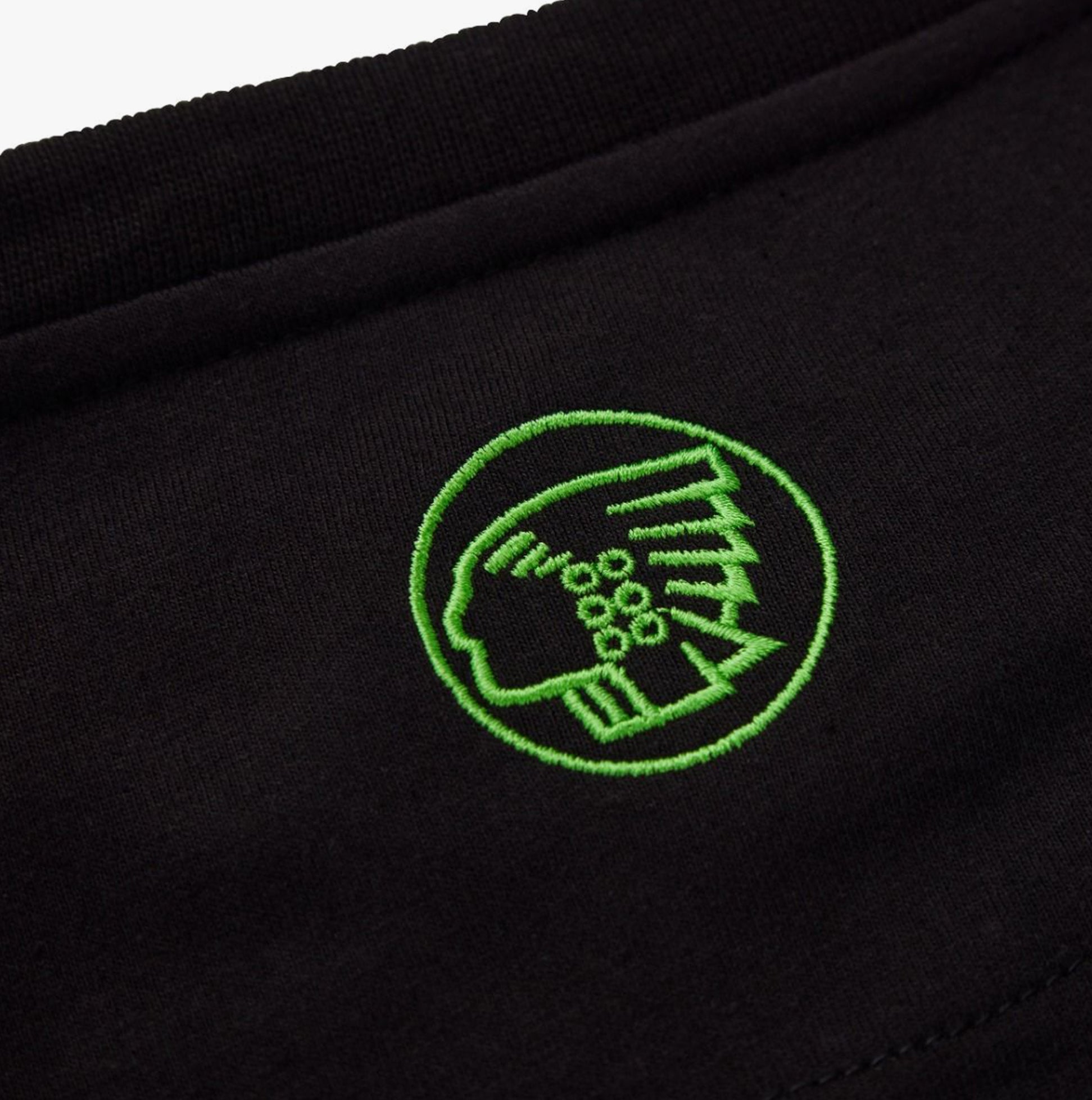 Apache DELTA Mens Workwear T-Shirt Black close-up view of debossed green chest logo.