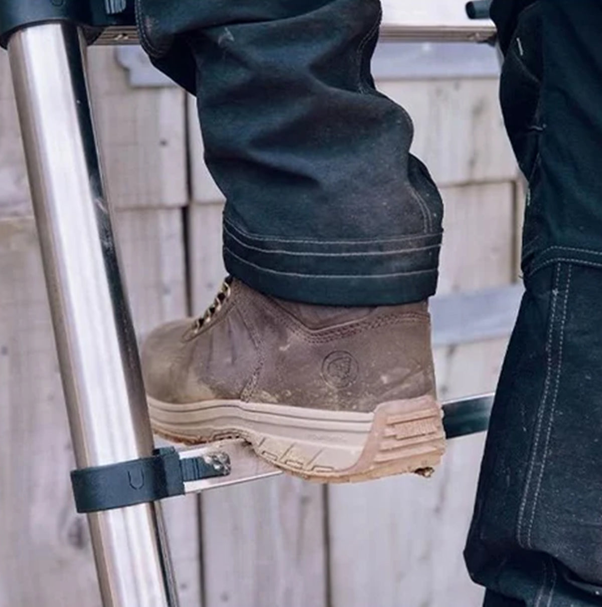 Apache MOOSE Unisex Boots Brown side view on a ladder showing durability and comfort features.