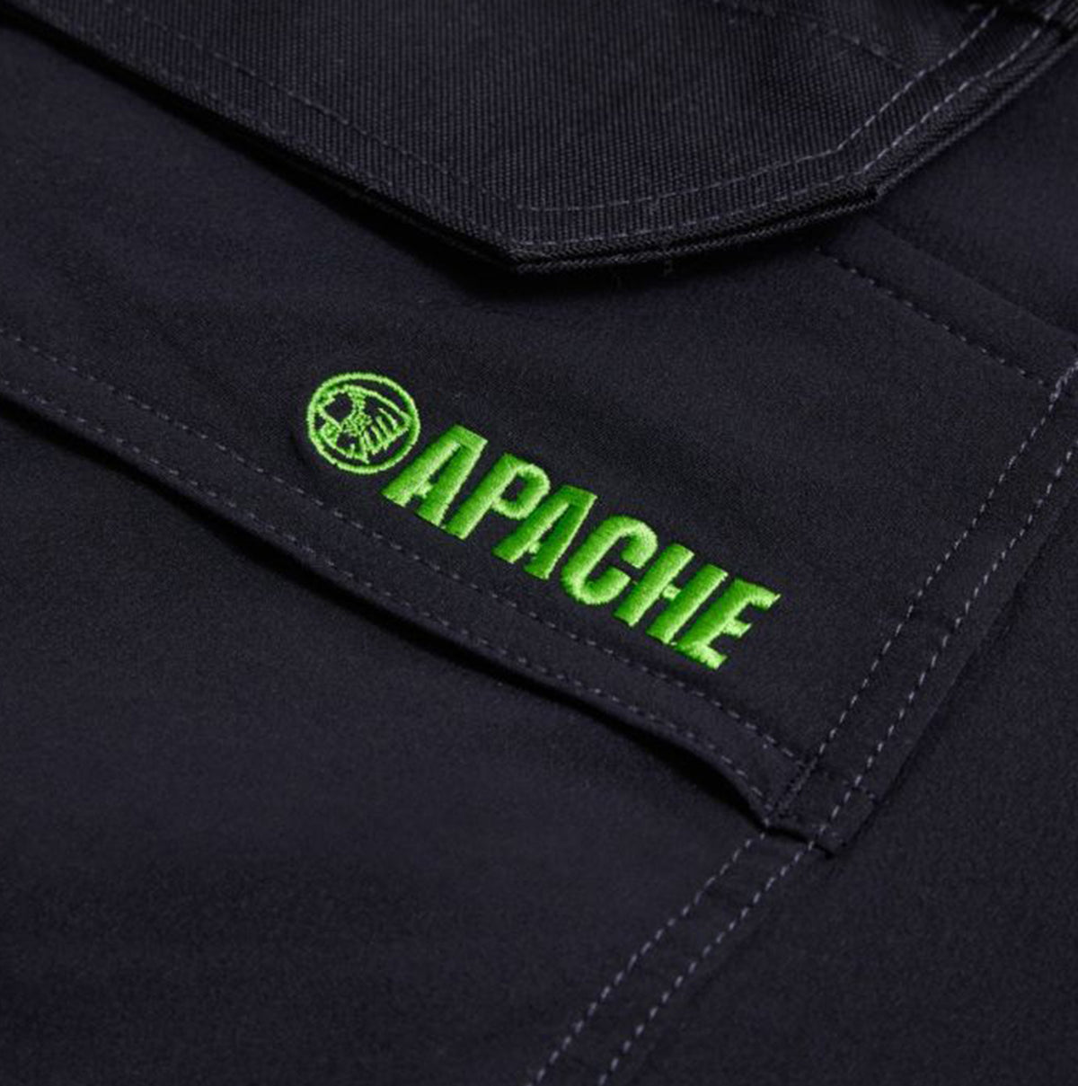 Detail view of Apache WHISTLER Mens Workwear Shorts Black featuring green logo embroidery.