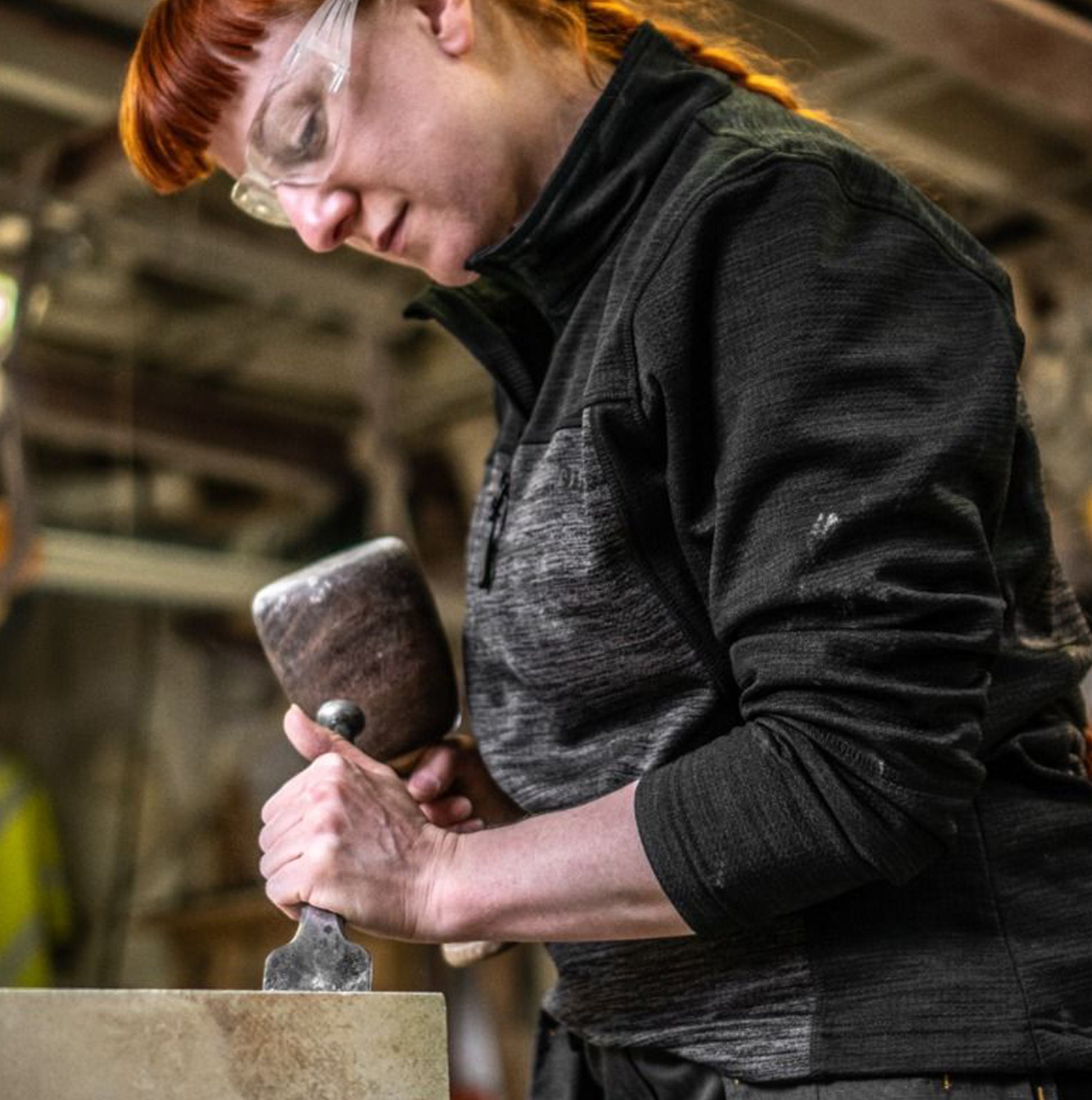 Dewalt CHARLOTTE Womens Sweatshirt Grey Black front view worn by a woman using a chisel in a workshop.